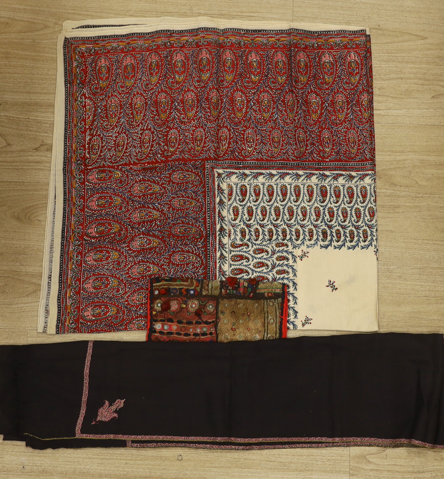 A 19th century Indian mirrored square, a printed summer paisley shawl and a black wool and embroidered stole, summer shawl 156cm square